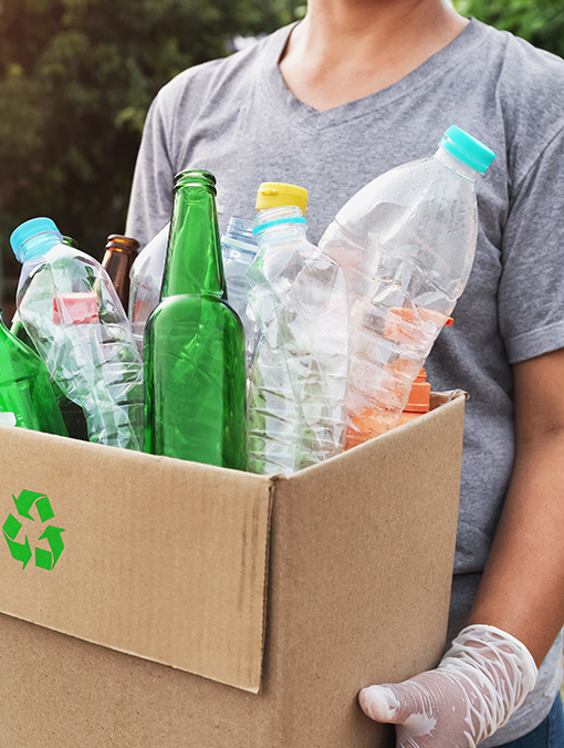 Stock imagery of woman holding recycling bin